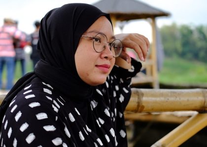 a woman in a black and white top and glasses